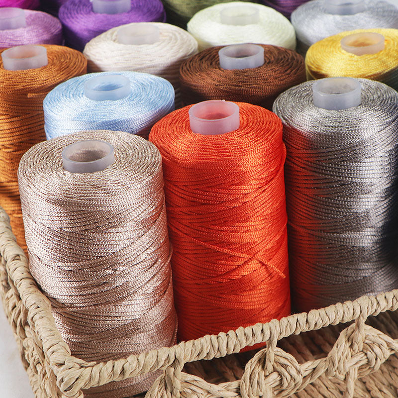 Assorted spools of thread in various colors arranged in a basket.